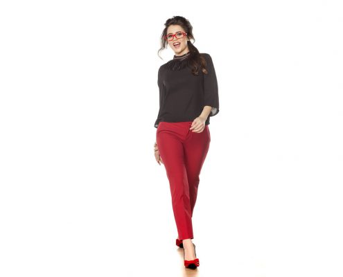 attractive brunette in red pants posing in the studio